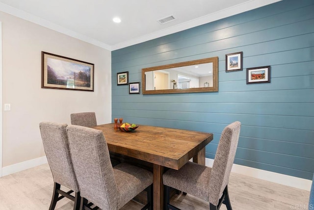 4304 Pacifica Way Unit 2, Oceanside, CA 92056 - dining room featuring light wood finished floors, ornamental molding, wood walls, and recessed lighting