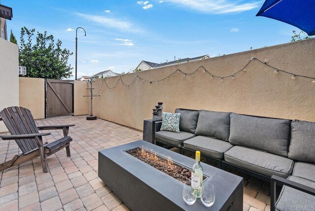 4304 Pacifica Way Unit 2, Oceanside, CA 92056 - view of patio / terrace with a gate and an outdoor living space with a fire pit