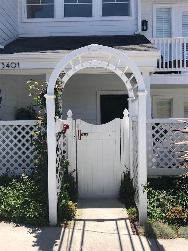 3401 5th Ave, Corona Del Mar, CA 92625 - doorway to property featuring a shingled roof, fence, and a balcony