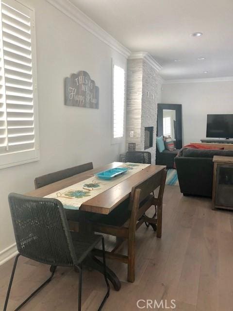 3401 5th Ave, Corona Del Mar, CA 92625 - dining area with wood finished floors, ornamental molding, and a fireplace