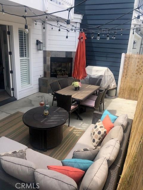 3401 5th Ave, Corona Del Mar, CA 92625 - view of patio / terrace with an outdoor living space with a fireplace, outdoor dining area, and fence