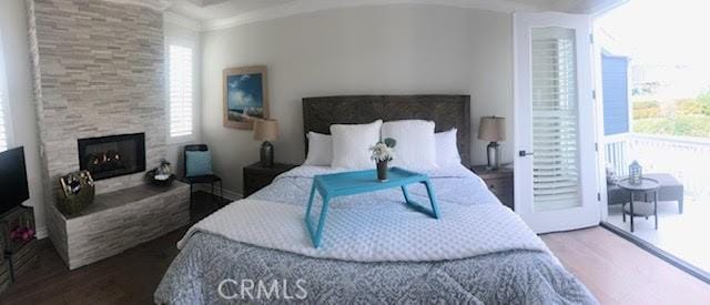 3401 5th Ave, Corona Del Mar, CA 92625 - bedroom featuring wood finished floors, multiple windows, a fireplace, and crown molding