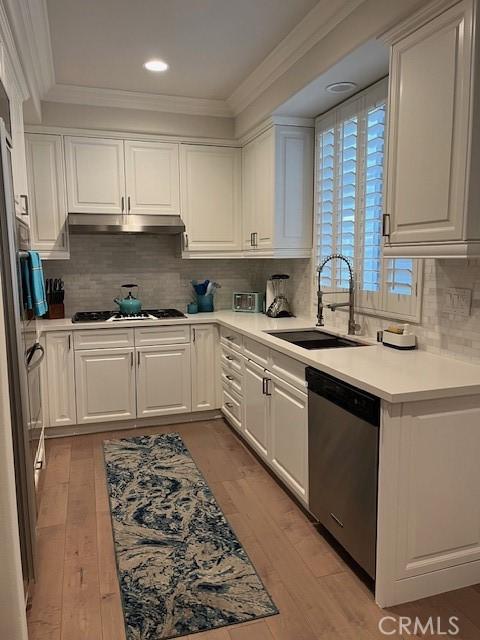 3401 5th Ave, Corona Del Mar, CA 92625 - kitchen with dishwasher, ornamental molding, a sink, white cabinets, and recessed lighting