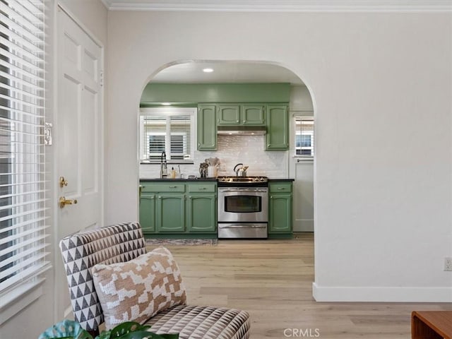715 Bennett Ave, Arroyo Grande, CA 93420 - kitchen with green cabinets, electric range, arched walkways, under cabinet range hood, and light wood-type flooring