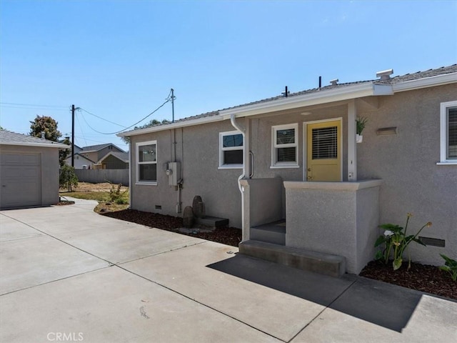 715 Bennett Ave, Arroyo Grande, CA 93420 - rear view of property with driveway, a garage, stucco siding, and fence