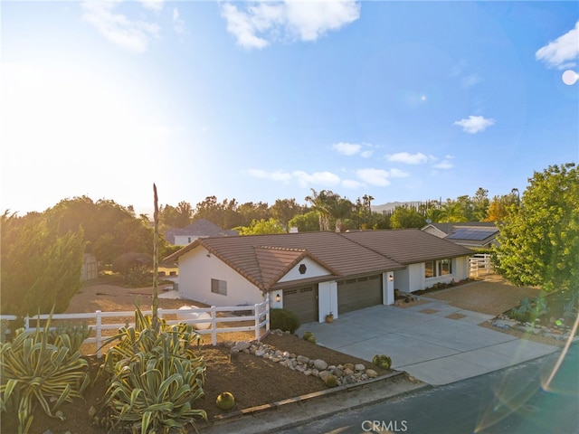 29140 Via Norte, Temecula, CA 92591 - view of front of house featuring a garage, a tiled roof, driveway, and stucco siding