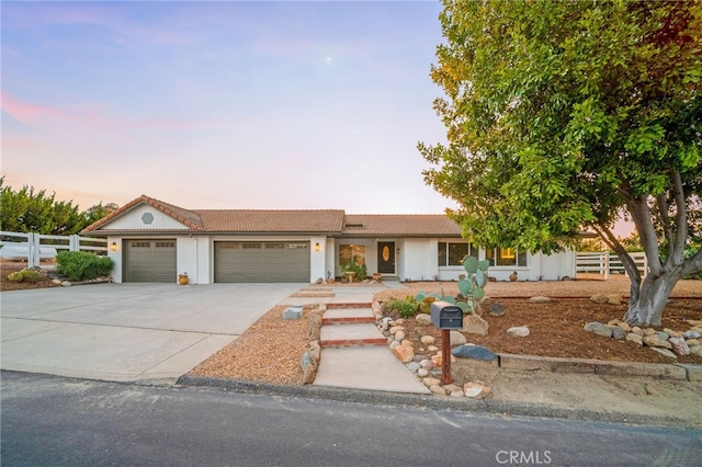 single story home featuring a garage, fence, driveway, stucco siding, and a tile roof