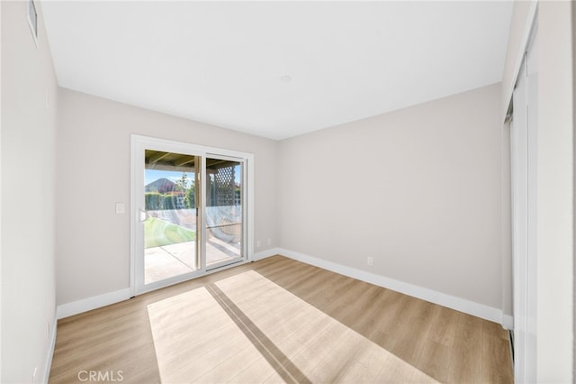 unfurnished room featuring wood finished floors and baseboards
