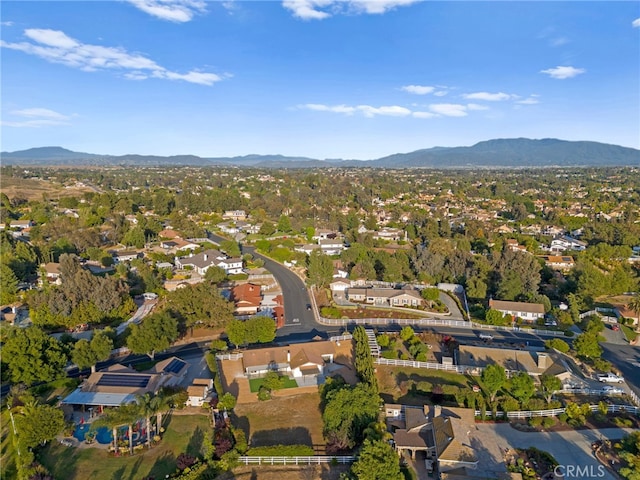 aerial overview of property's location with a mountain backdrop and nearby suburban area