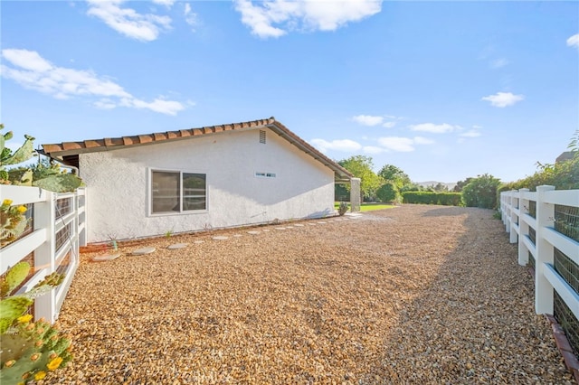 view of home's exterior featuring fence and stucco siding