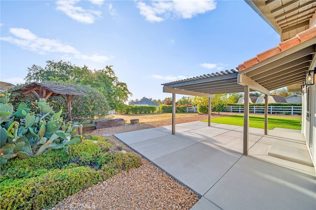 view of patio featuring fence and a pergola