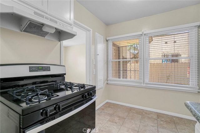 1922 Locust Ave, Long Beach, CA 90806 - kitchen with stainless steel gas range, under cabinet range hood, baseboards, and light tile patterned floors
