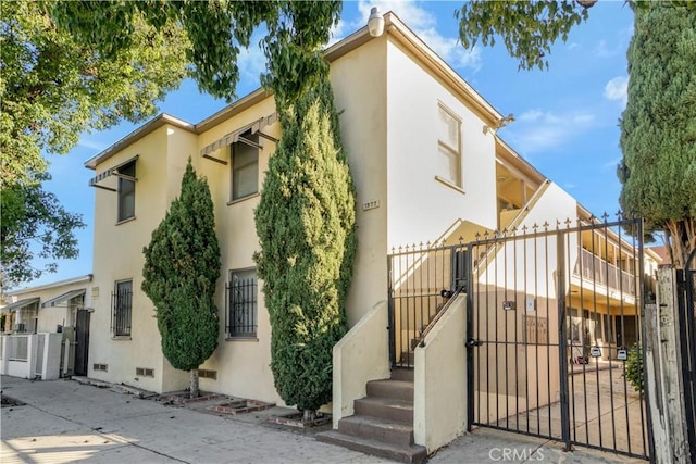 1922 Locust Ave, Long Beach, CA 90806 - view of home's exterior with a gate, stucco siding, and fence