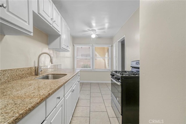 1922 Locust Ave, Long Beach, CA 90806 - kitchen featuring gas stove, a sink, baseboards, and white cabinets
