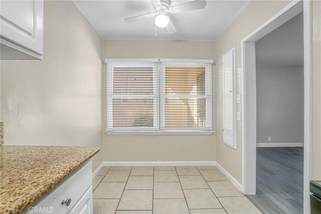 1922 Locust Ave, Long Beach, CA 90806 - unfurnished dining area featuring a ceiling fan, baseboards, and light tile patterned flooring