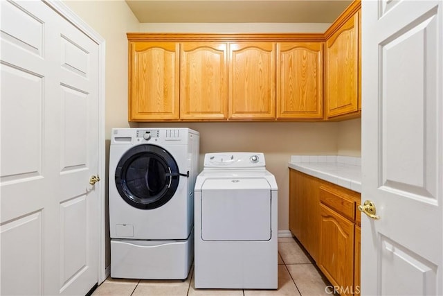 9539 Carmel Rd, Atascadero, CA 93422 - laundry area with cabinet space, washing machine and clothes dryer, and light tile patterned flooring