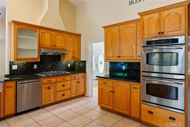 9539 Carmel Rd, Atascadero, CA 93422 - kitchen with appliances with stainless steel finishes, under cabinet range hood, light tile patterned floors, glass insert cabinets, and backsplash