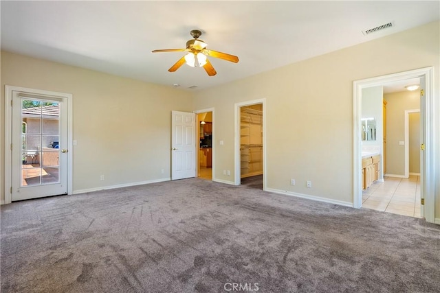 9539 Carmel Rd, Atascadero, CA 93422 - unfurnished bedroom with carpet, a walk in closet, baseboards, ensuite bathroom, and access to exterior