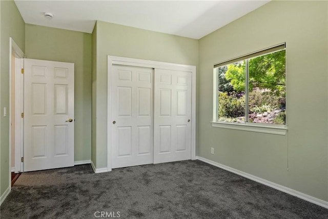 9539 Carmel Rd, Atascadero, CA 93422 - unfurnished bedroom featuring dark colored carpet, a closet, and baseboards