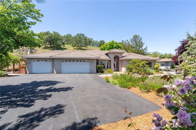 9539 Carmel Rd, Atascadero, CA 93422 - view of front of house featuring stucco siding, driveway, a garage, and a tiled roof