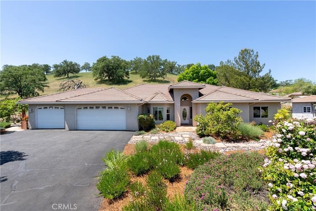 9539 Carmel Rd, Atascadero, CA 93422 - view of front facade with a garage, stucco siding, asphalt driveway, and a tile roof