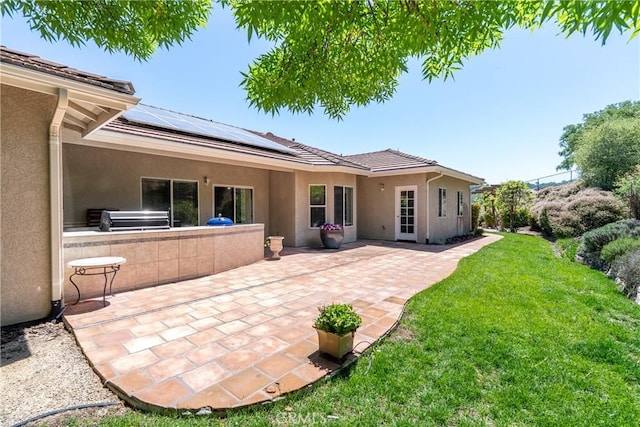 9539 Carmel Rd, Atascadero, CA 93422 - rear view of house featuring stucco siding, a lawn, solar panels, a patio, and area for grilling