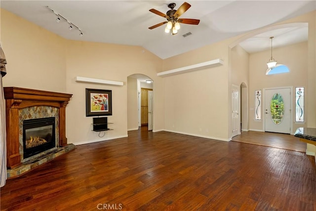 9539 Carmel Rd, Atascadero, CA 93422 - unfurnished living room with ceiling fan, wood finished floors, a high end fireplace, arched walkways, and lofted ceiling