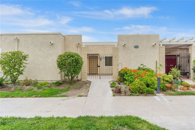 2202 Via Mariposa E Unit B, Laguna Woods, CA 92637 - view of building exterior featuring a fenced front yard
