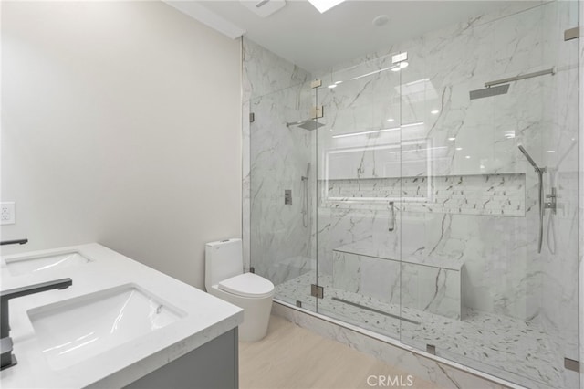 2202 Via Mariposa E Unit B, Laguna Woods, CA 92637 - bathroom featuring toilet, a marble finish shower, double vanity, and wood finished floors