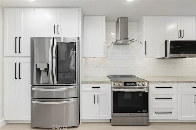 2202 Via Mariposa E Unit B, Laguna Woods, CA 92637 - kitchen featuring appliances with stainless steel finishes, wall chimney exhaust hood, white cabinetry, and light stone countertops