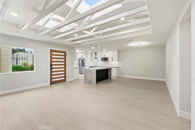 2202 Via Mariposa E Unit B, Laguna Woods, CA 92637 - unfurnished living room with recessed lighting, baseboards, light wood-style flooring, and beamed ceiling