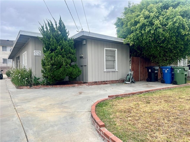 view of front of property featuring board and batten siding and fence