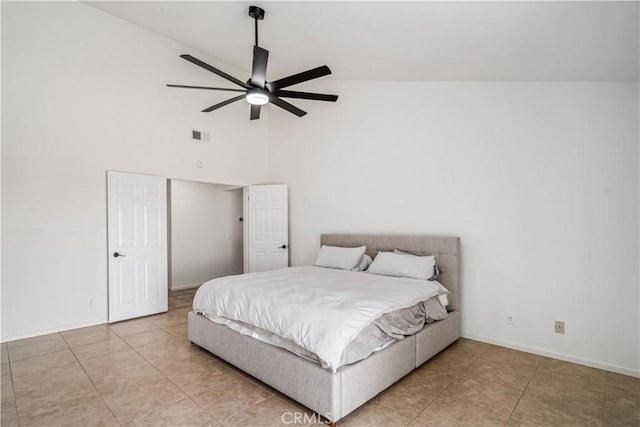 bedroom featuring light tile patterned floors, baseboards, high vaulted ceiling, and a ceiling fan