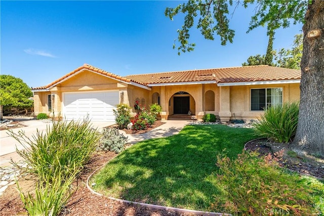 mediterranean / spanish-style house with a garage, stucco siding, a front lawn, concrete driveway, and a tile roof