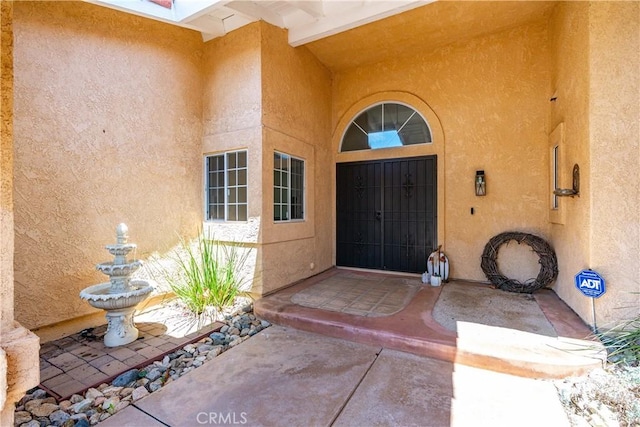 property entrance with stucco siding