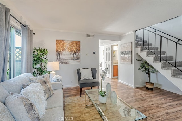 762 Dragonfly Ct, San Jose, CA 95133 - living room featuring light wood finished floors, stairs, baseboards, and crown molding