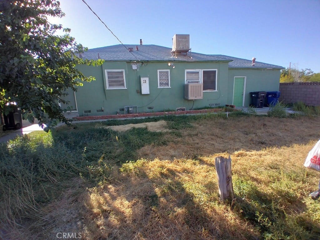 44520 Date Ave, Lancaster, CA 93534 - rear view of property with stucco siding and a shingled roof