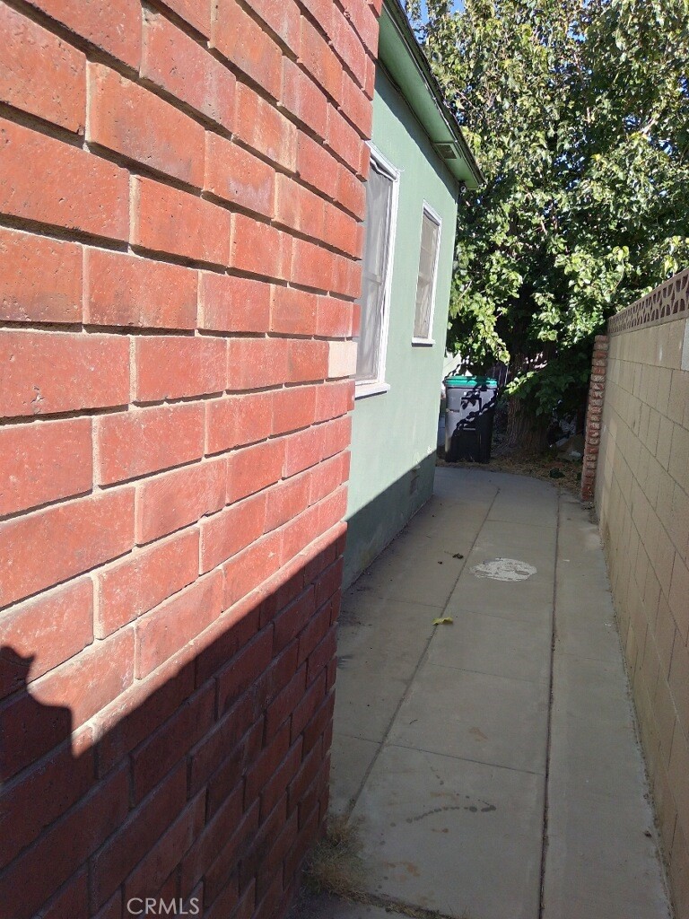 44520 Date Ave, Lancaster, CA 93534 - view of home's exterior featuring a patio area, crawl space, and fence