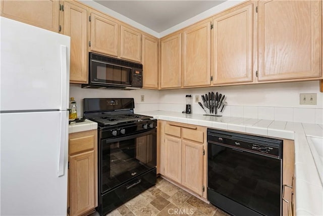 25141 La Jolla Way Unit F, Laguna Niguel, CA 92677 - kitchen with black appliances, light brown cabinets, and stone finish floors
