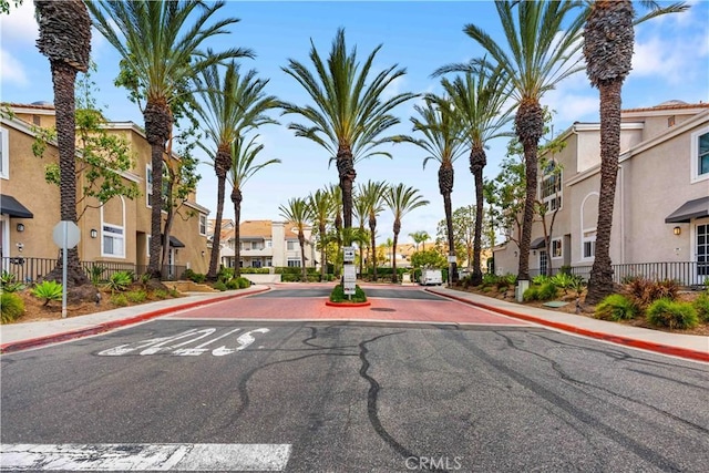 25141 La Jolla Way Unit F, Laguna Niguel, CA 92677 - view of asphalt road with a residential view, sidewalks, curbs, street lights, and traffic signs