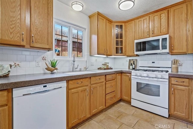 1360 El Moro Ave, Los Osos, CA 93402 - kitchen featuring white appliances, a sink, decorative backsplash, glass insert cabinets, and dark countertops