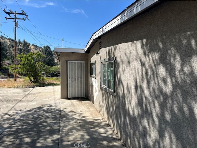 view of property exterior featuring stucco siding and a patio area