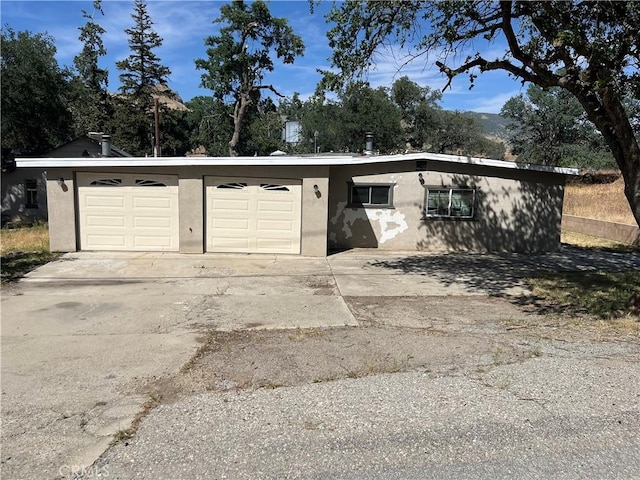 garage featuring concrete driveway