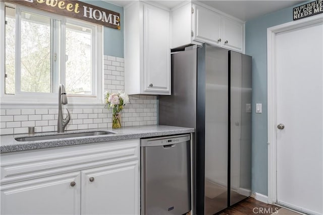 2871 Anza Ln, Costa Mesa, CA 92626 - kitchen featuring appliances with stainless steel finishes, a sink, backsplash, and white cabinets