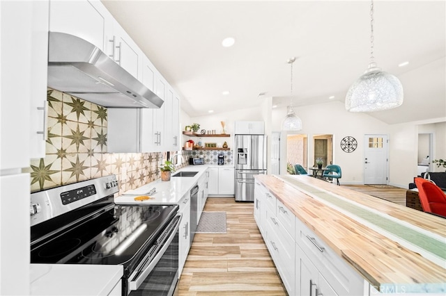 54415 Eisenhower Dr, La Quinta, CA 92253 - kitchen featuring stainless steel appliances, butcher block counters, under cabinet range hood, open shelves, and lofted ceiling