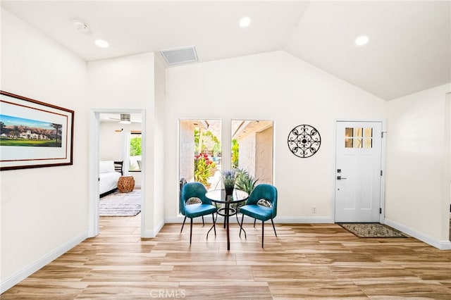 54415 Eisenhower Dr, La Quinta, CA 92253 - foyer featuring light wood-style floors, vaulted ceiling, baseboards, and recessed lighting