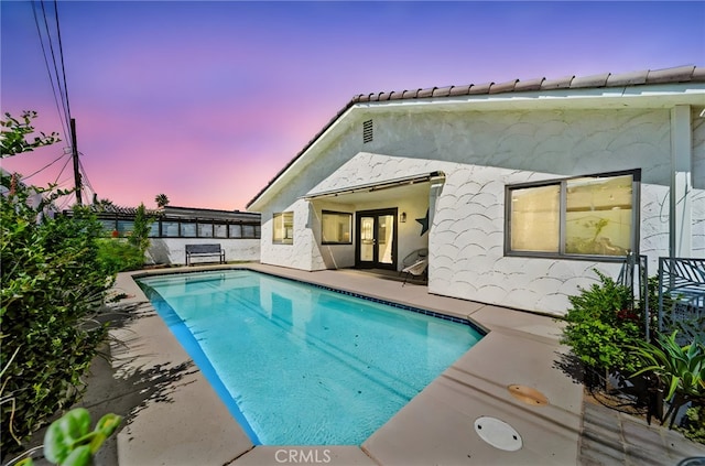 54415 Eisenhower Dr, La Quinta, CA 92253 - back of house featuring french doors, a patio, and stucco siding