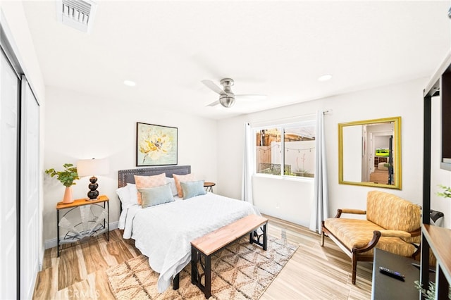 54415 Eisenhower Dr, La Quinta, CA 92253 - bedroom with light wood-type flooring, a closet, recessed lighting, a ceiling fan, and baseboards