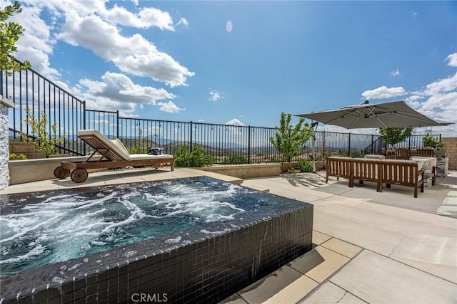view of patio / terrace featuring fence and an outdoor hot tub