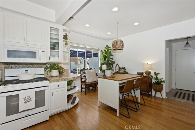 11934 Timber Mountain Ct, Rancho Cucamonga, CA 91739 - kitchen with white appliances, white cabinetry, glass insert cabinets, light wood finished floors, and recessed lighting